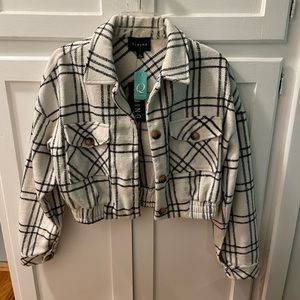 White cropped jacket with black stripes and button